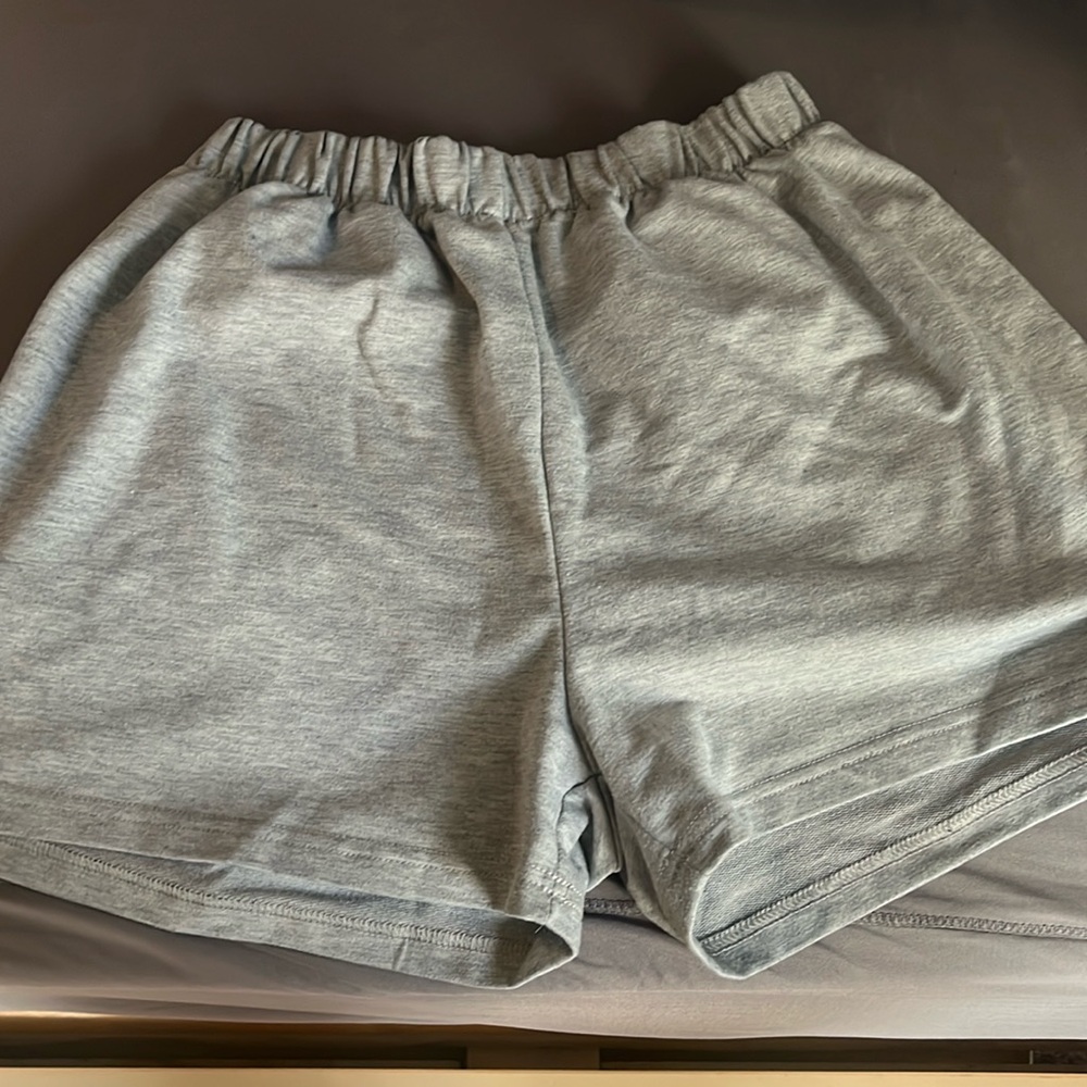 gray shorts with sun and moon on pockets